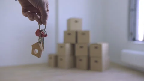 A hand grasps keys against a backdrop of containers. Stock Footage 313679148