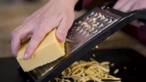 Hand grates cheese in slow motion Stock-Footage 221434643