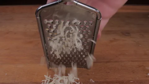 Hand grating cheese with grater slow motion 4k Stock Footage 149694392