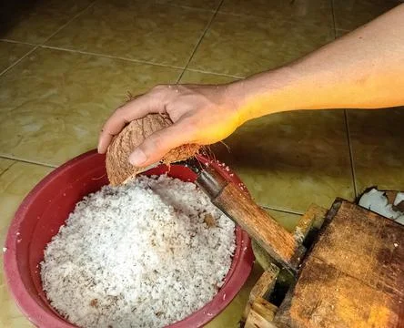 Hand grating coconut Stock Photos