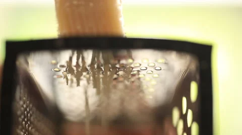 Hand grating yellow cheese with a metal grater. Closeup Stock Footage 51933019
