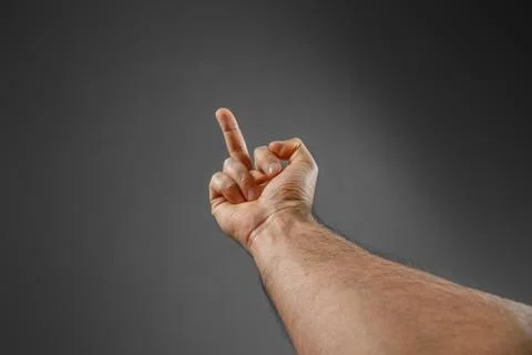 Hand on a gray background. "back off" gesture. Stock Photos