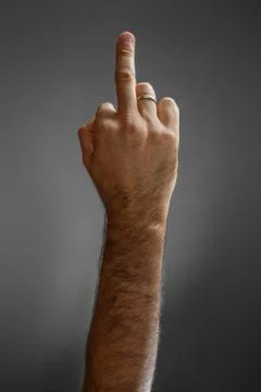 Hand on a gray background. "back off" gesture. Stock Photos