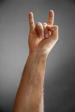 Hand on a gray background. Stock Photos