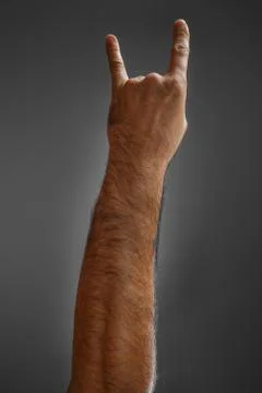 Hand on a gray background. Stock Photos