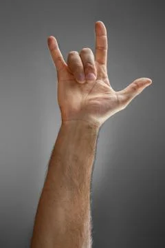 Hand on a gray background. Stock Photos