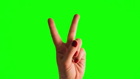 A hand on a green background shows a victory gesture. Green screen mockup. 스톡 동영상 335806960