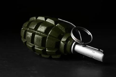 Hand grenade on black background, closeup. Explosive weapon Stock Photos