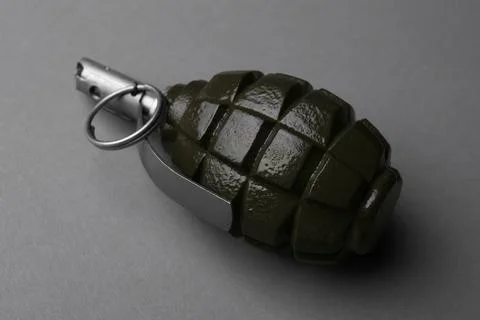 Hand grenade on grey background, closeup. Explosive weapon Stock Photos