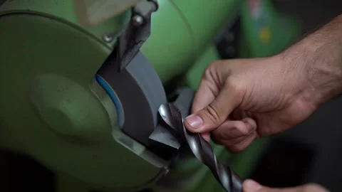 A hand grinding a drill with a drill grinding machine Video stock 203855792