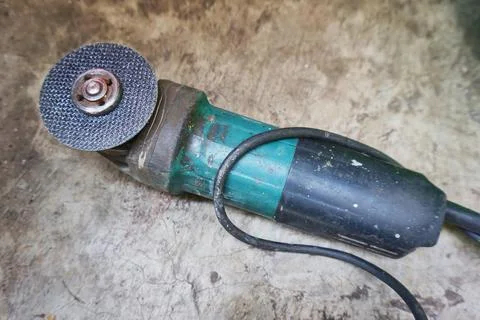 Hand grinding machine on cement floor Stock Photos