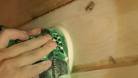 A hand with a grinding machine at the construction site. Male carpenter using a Stock Footage 162447331