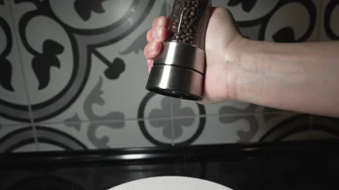 Hand grinds pepper mill slow motion Stock Footage 156223026