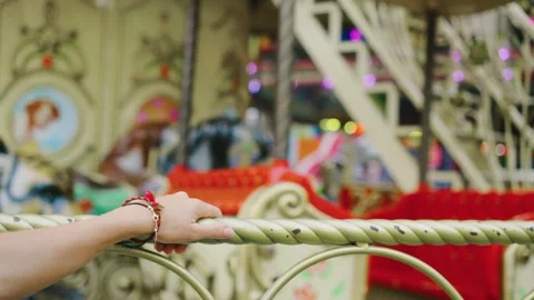 A hand griping a colorful carousel railing Video stock 283504608