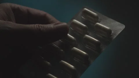 Hand Gripping Blister Pack of Capsules Stock Footage 278513645