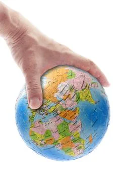 Hand gripping globe Stock Photos
