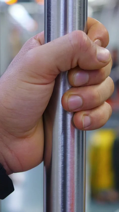 Hand Gripping a Pole in the Subway to Avoid Falling Stock Footage 295143309