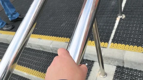 Hand gripping railing while ascending st... | Stock Video | Pond5
