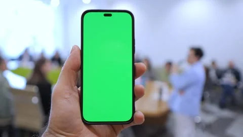 Hand grips phone with solid green screen Stock Footage 341176209