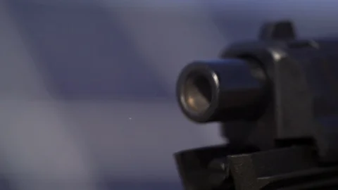 Hand gun barrel firing close up in slow motion Stock Footage