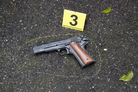 Hand gun at a crime scene Stock Photos