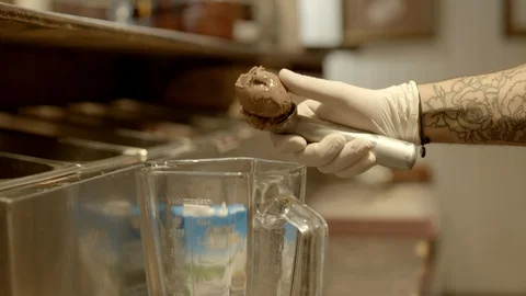 The hand of the guy puts ice cream in a blender. Slow motion 스톡 동영상 122634684