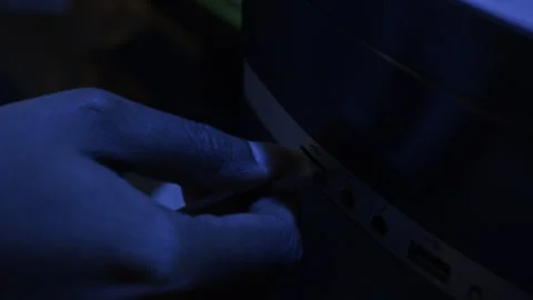 Hand of Hacker Plugging USB Cable into Computer in Office at Night Stock Footage 328244392