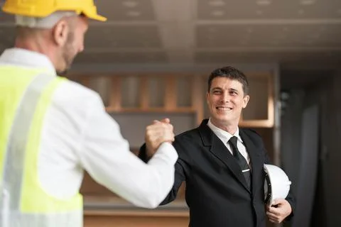 Hand in hand between project contractors and customers due to negotiation of Stock Photos