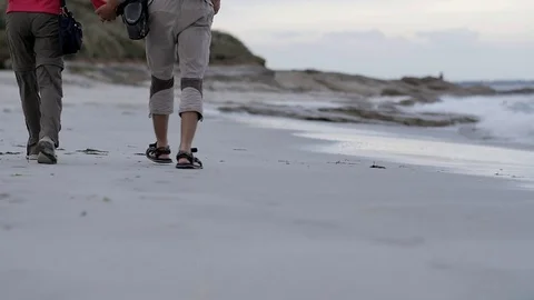 Hand in hand in the evening in a Breton beach -slow motion Stock Footage 70310802