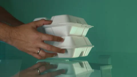 Hand-to-hand handover of a disposable two plastic lunch boxes Stock Footage 167804977