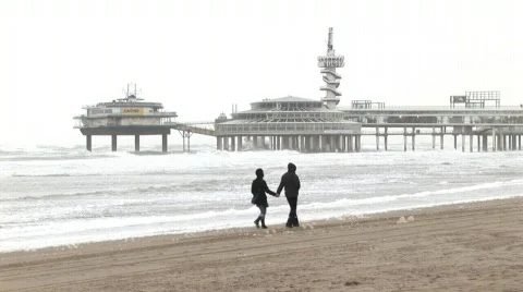 Hand in hand through the Storm, beach Schevingen Netherlands Stock Footage 815388