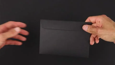 Hand to hand transfer or redirection black envelope, suspicious correspondence Stockbeeldmateriaal 138890828