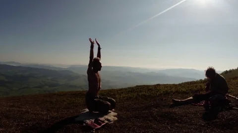 Hand in hand underfoot in a complex pose close-up of yoga in nature, bright clot Stock Footage 77787597