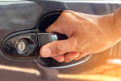 Hand on handle Close up of man hand opening car door Stock Photos