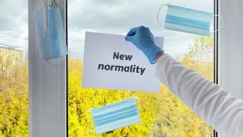 Hand hanging sheet of paper with word New normality Stock Footage 162482614