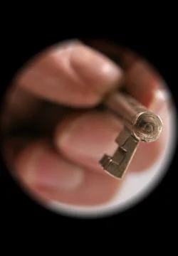Hand heading with a key to the keyhole Stock Photos