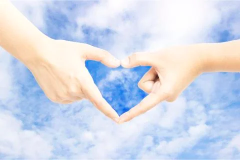 Hand heart shape sky background Stock Photos