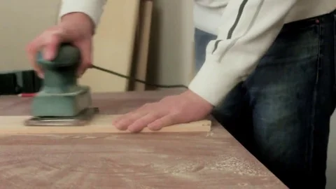 Hand-held belt sander at finished wood furniture Stock Footage 69205480