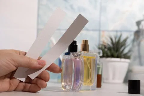 Hand-held blotter strips test fragrances to compose complex aroma blends Stock Photos