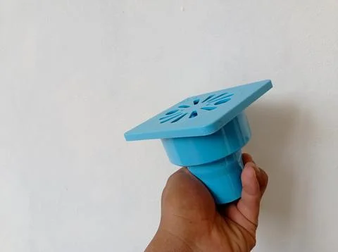 Hand held blue plastic sewer filter. floor drain Stock Photos