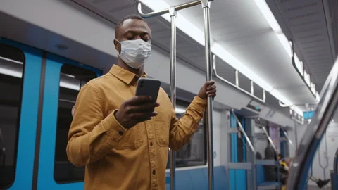 Hand-held camera. An African-American man with a mobile phone in the subway Stock Footage 279730819