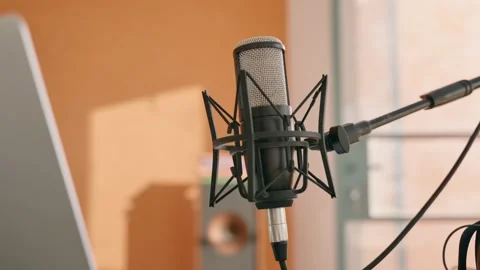 Hand held camera push in on professional microphone next to computer on desk Stock Footage 218475847