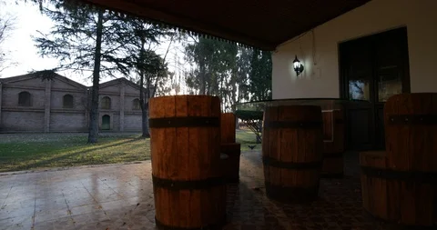 Hand held camera showing colonial house porche, oak tanks of wine Video stock 97319750