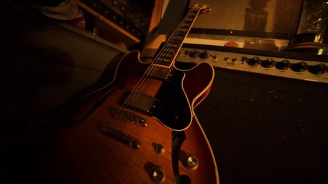 A hand held camera tilts up from a Yamaha SA-20 then across a garage band Stock Footage 102828225
