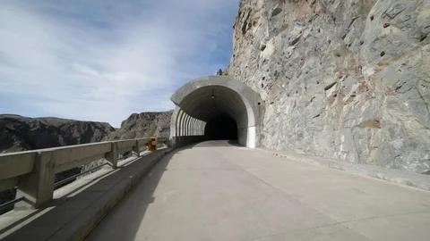 Hand held camera walking towards and getting in a brutalist concrete tunnel Stockbeeldmateriaal 95581426
