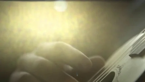 Hand held close-up of man playing guitar on a sunny day 스톡 동영상 72505873