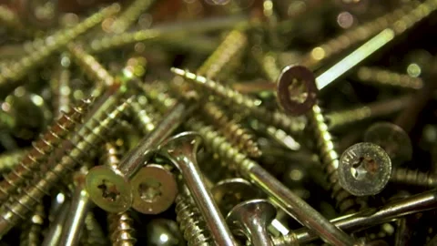 Hand held close up shallow depth of brass screews Stock Footage 310795531