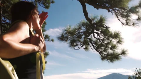 Hand-held close up of woman with a backpack on a mountain top Stock Footage 138477115