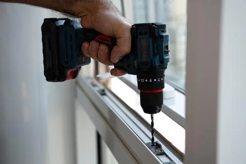 Hand-held Cordless Drill in Action, Close-up Installation Shot Stock Photos