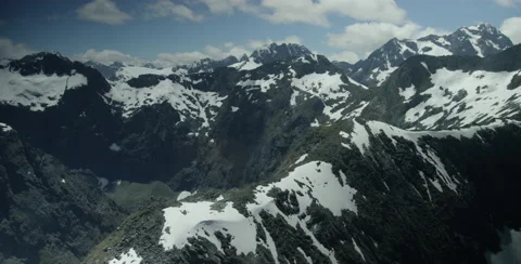 Hand held flying over New Zealand's snow covered mountains. Stock Footage 64448380